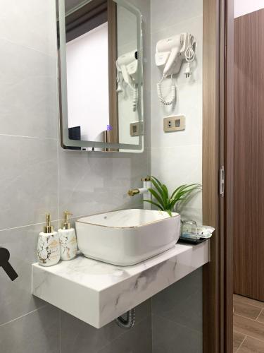 a bathroom with a white sink and a mirror at KING HOTEL in Ha Long