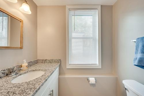 a bathroom with a sink and a window at New Hampshire Abode with Mountain Views, Near Skiing in Tamworth