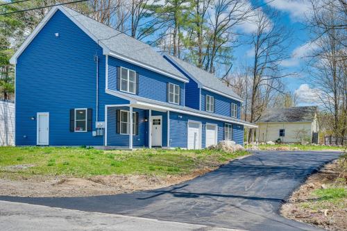 a blue house with a driveway in front of it at New Hampshire Abode with Mountain Views, Near Skiing in Tamworth
