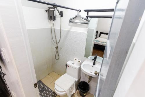 a small bathroom with a toilet and a sink at OCEANVIEW HOMESTAY in Alaminos