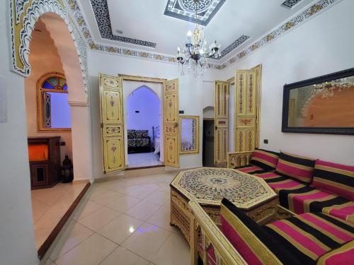 a living room with a table and chairs at Blue City in Chefchaouen