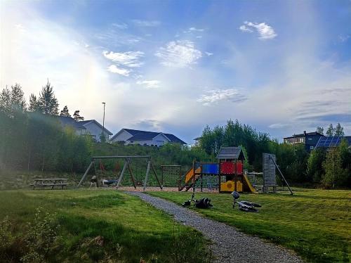 a playground in a park with a gravel path at Modern, private spacious & fully equipped for 2-6 people Near forest, with kitchen, washer, pets friendly in Floda