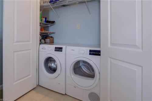 a white laundry room with a washer and dryer at Coastal Beach Condo-Amazing View & Indoor Pool 13th Floor in Virginia Beach