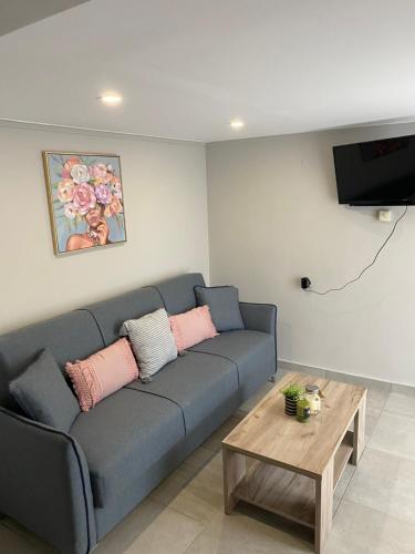 a living room with a blue couch and a coffee table at Ambelos Skala in Mytilini