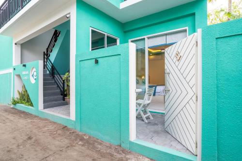 a house with a blue and white exterior at Ukulhas Sands in Ukulhas