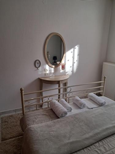 a bedroom with a bed with a mirror on the wall at M home place in Palio Limani