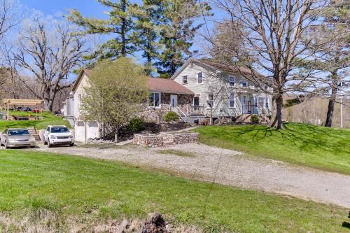 a house with a car parked in the driveway at Cozy Conesus Vacation Rental Near Wineries and Lake! in Conesus