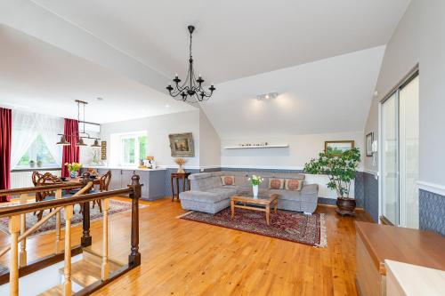 a living room with a couch and a table at Cozy apartments by the river near old town in Kaunas