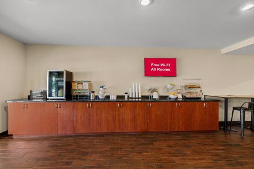 a counter in a room with a sign on the wall at Red Roof Inn & Suites Albany, GA in Albany