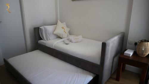 a small bedroom with a bed and a night stand at The Grove Retreat - Cozy 2BR Comfort Home in Masdar City, Near Masdar Institute in Abu Dhabi