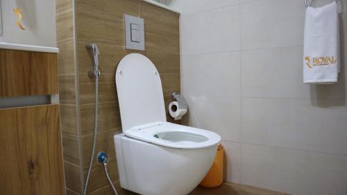 a bathroom with a toilet with the lid up at The Grove Retreat - Cozy 2BR Comfort Home in Masdar City, Near Masdar Institute in Abu Dhabi