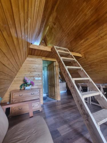a room with a bunk bed and a staircase in a cabin at Cabana A-frame Moon Predelut in Predeluţ