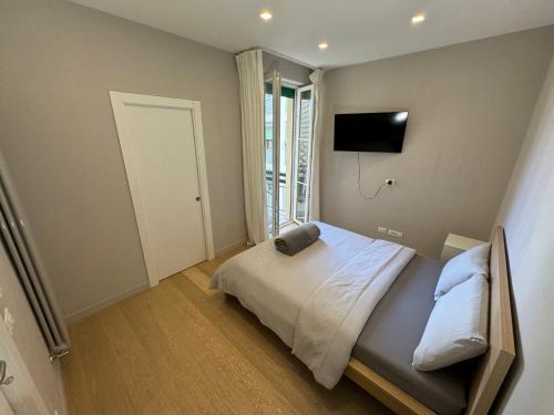 a bedroom with a bed and a tv on the wall at Florence Modern Apartment SELF CHECK-IN in Florence