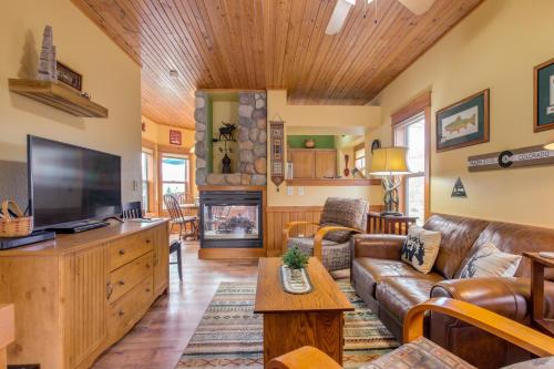a living room with a couch and a tv at Riverfront Cabin 4 Mi to Granby Ranch in Granby