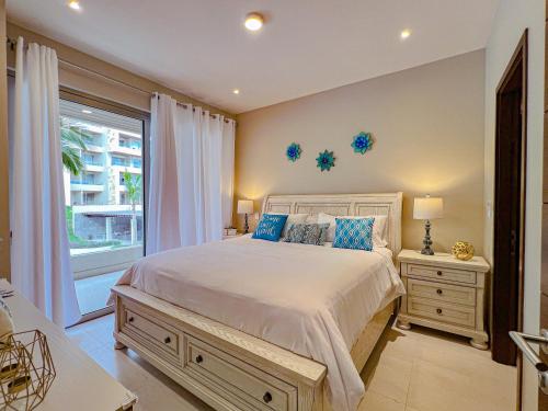 a bedroom with a large bed and a window at New Condo! Vista Velas III in El Pueblito