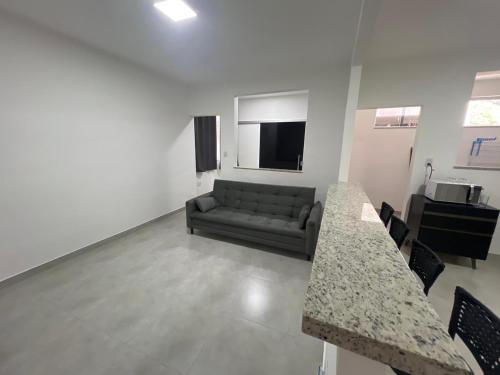 ein Wohnzimmer mit einem Sofa und einem TV in der Unterkunft Executivo Veneza in Ipatinga