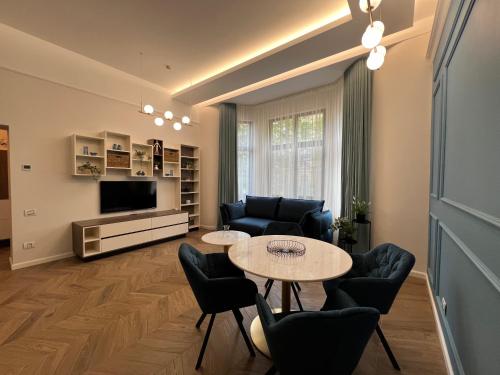 a living room with a table and chairs at PoshSpot Apartments in Cluj-Napoca