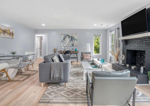 a living room filled with furniture and a fireplace at Stylish Home Near Uptown, UNC, and More! in Charlotte