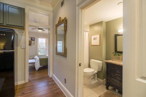 a bathroom with a toilet and a mirror at Private Patio Retreat in Charming Downtown in Savannah