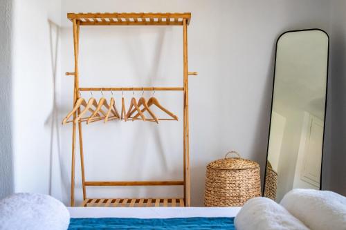 a dressing room with a mirror and a bed at Marani Home & Villas in Skopelos Town