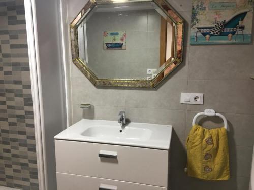a bathroom with a sink and a mirror at La casa de Manuel en Ortigueira in A Coruña