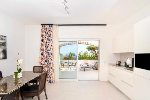 a kitchen and dining room with a view of a patio at Le donne di Capri - Charming apartments in Capri in Capri