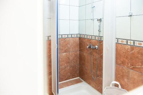 a shower with a glass door in a bathroom at Apartments Djurovic in Kotor
