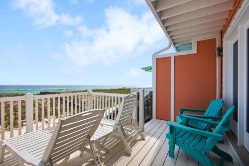 two chairs on a deck with a view of the ocean at Life's A Beach Townhouse in Navarre