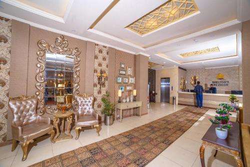 a lobby of a hotel with two chairs and a table at Shelton's Rezidor Peshawar in Peshawar