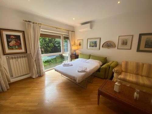 a bedroom with a bed and a couch and a window at Vicario138 in Rome