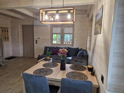 a living room with a table and a couch at Wiele Żurawi in Wiele