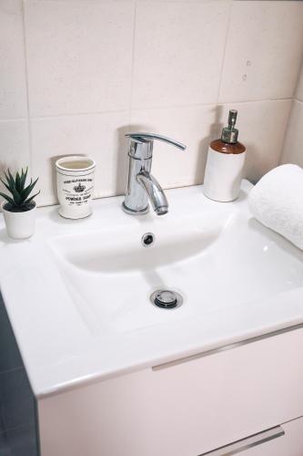 a white bathroom sink with plants on it at Villa Infinity View Athens Riviera in Anavissos