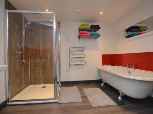 a bathroom with a shower and a bath tub at 3 Bed in Penzance 1.5 mls 75635 in Gulval