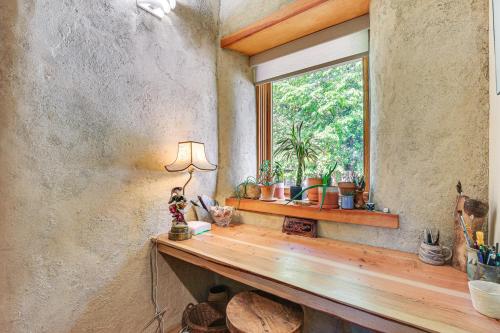 a room with a window and a wooden counter with plants at Unique and Serene Retreat, 7 Mi to Downtown Portland in Portland