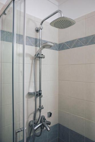a bathroom with a shower with a glass door at Villa Infinity View Athens Riviera in Anavissos
