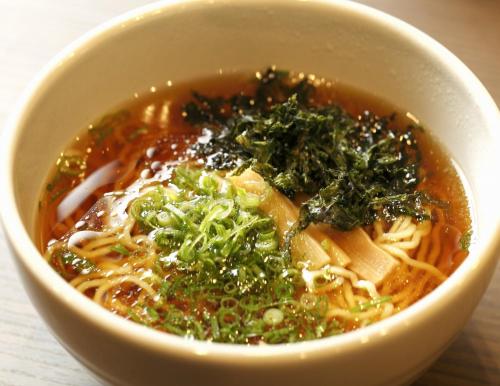 a bowl of soup with noodles and greens at Dormy Inn Morioka in Morioka