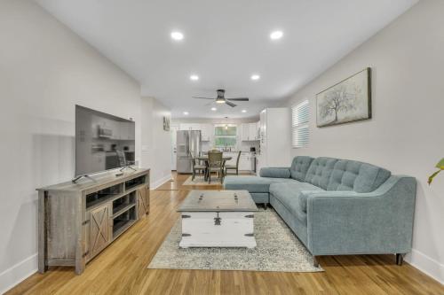 a living room with a couch and a table at Single Story Pet Friendly Home, with Fenced Yard, Fire Pit, 5min to Downtown!! in Nashville