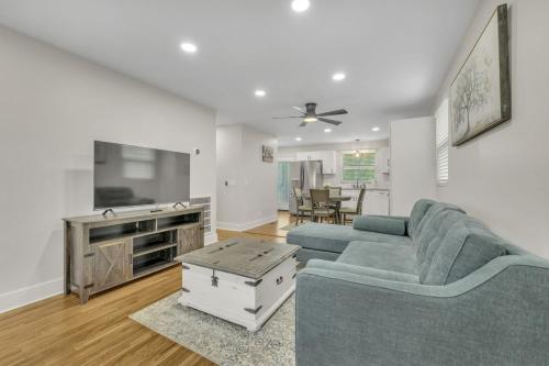 a living room with a couch and a table at Single Story Pet Friendly Home, with Fenced Yard, Fire Pit, 5min to Downtown!! in Nashville