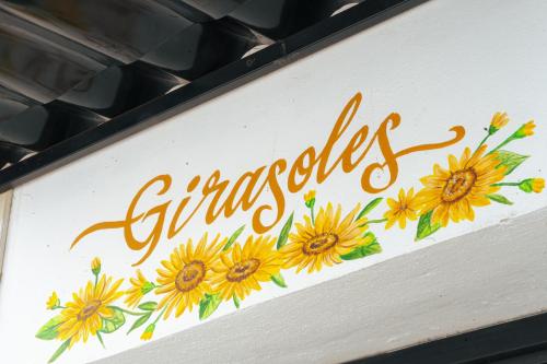 a sign with a bunch of sunflowers on it at Casa Don José: GIRASOLES Suite in Oaxaca City