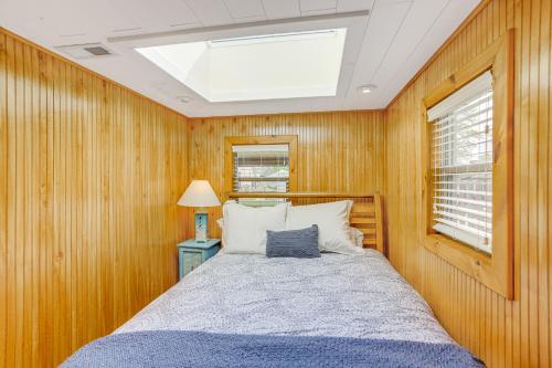 a bedroom with a bed and a skylight at Waterfront Port Clinton Cottage with Fire Pit! in Port Clinton