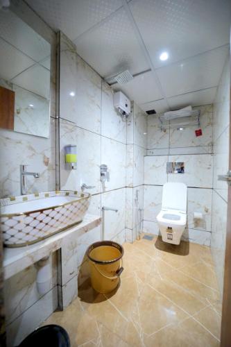 a bathroom with a toilet and a sink at N.M. Hotel in Mumbai