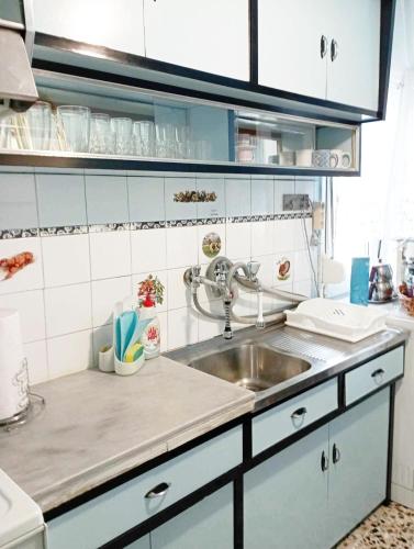 a kitchen with a sink and a counter top at Nicola's House with private parking in Kavála