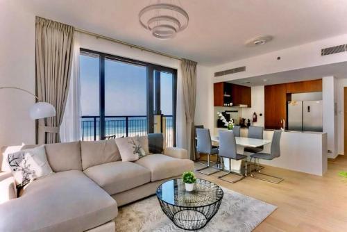 a living room with a couch and a table at Ocean Majestic Full Sea View at Le Pont in Dubai