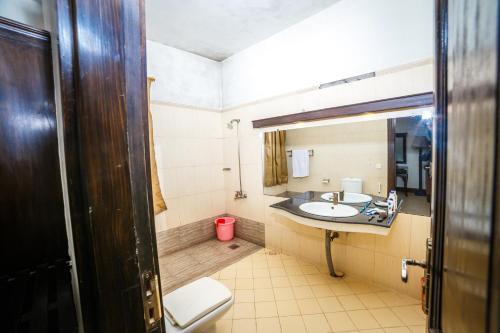 a bathroom with a sink and a toilet at Shelton House Peshawar in Peshawar