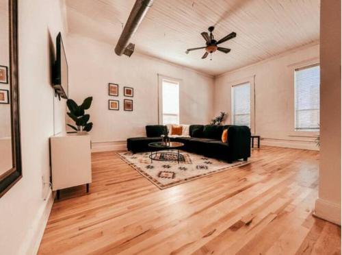 a living room with a couch and a ceiling fan at The Yellowrose in Waxahachie