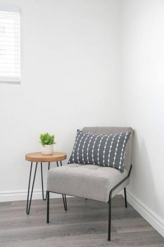 a chair with a pillow sitting next to a table at Enjoy Alhambra Night Life at 2BR Apt in Alhambra