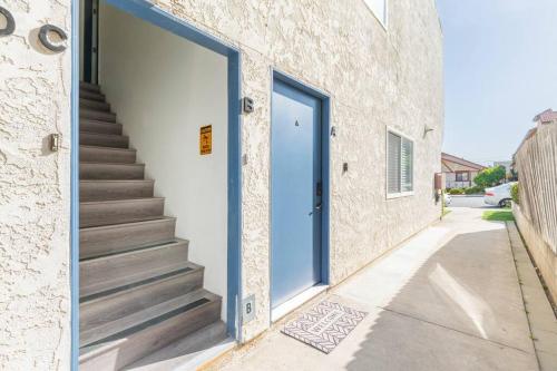 a doorway to a building with a staircase and a blue door at Enjoy Alhambra Night Life at 2BR Apt in Alhambra
