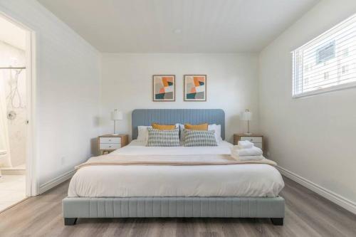 a bedroom with a large bed with a blue headboard at Enjoy Alhambra Night Life at 2BR Apt in Alhambra