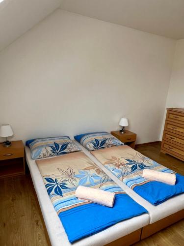 a bed in a room with two pillows on it at Apartmán D+D in Zázrivá