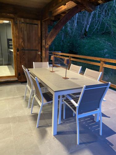 a wooden table and chairs on a patio at Chalet L'Alpaga in Châtel